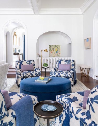 living room with blue chairs and purple pillows