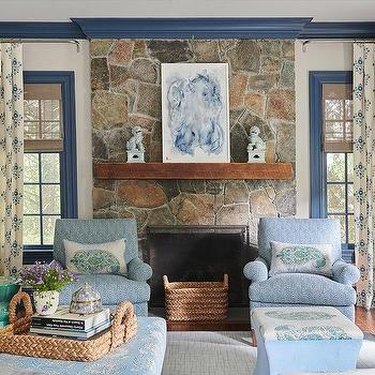 blue living room with large stone fireplace