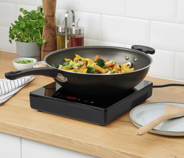 pan with stir fry on induction cooktop