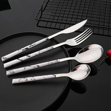 faux marble handle cutlery on black table