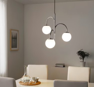 dining area with chandelier with three bulbs