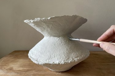Painting paper mache vase with light cream color