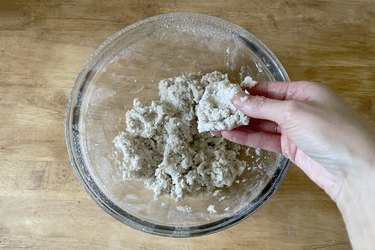 Mixing paper mache pulp with water in bowl