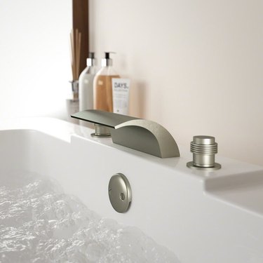 A garden tub faucet in a bathtub filled with water