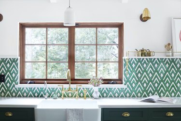 Kitchen sink with green tile backsplash
