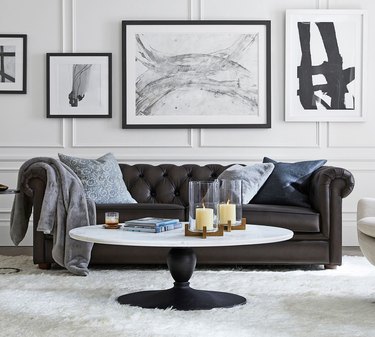 dark leather Chesterfield sofa in white living room