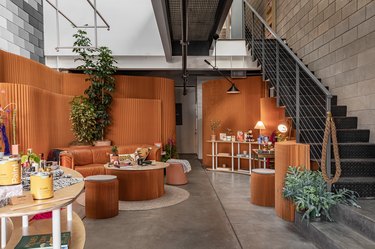 Black Spaces iteration of Hunker House showroom featuring products on shelving and seating area