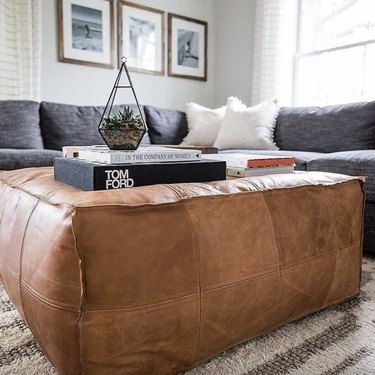 large leather pouf used as coffee table