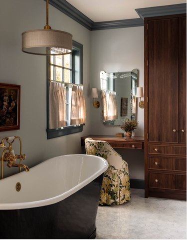 bathroom with a makeup vanity adjacent to floor-to-ceiling cabinetry