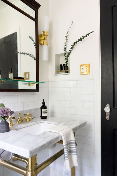 black and white bathroom with gold hardware