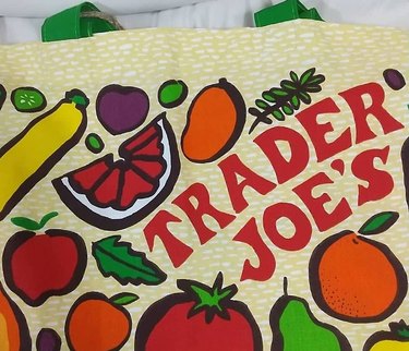 Trader Joe's reusable bag with fruit drawings on it.