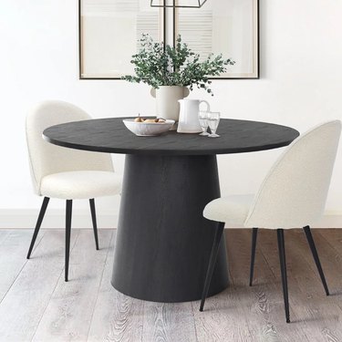 pedestal dining table with boucle chairs