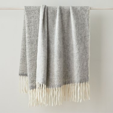 gray blanket with white fringe