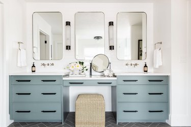 bathroom with white walls and sage green vanity