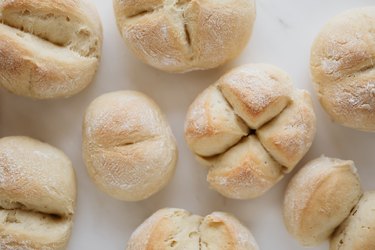 Rolls of bread on a white table