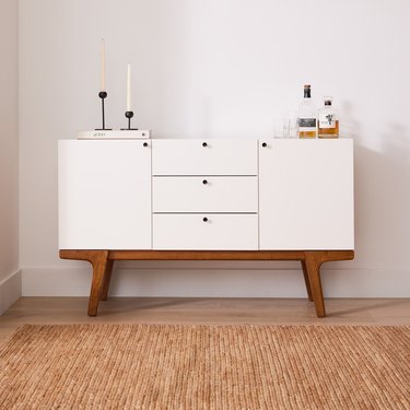 modern white buffet with wood legs
