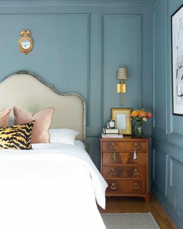 blue bedroom with cream headboard