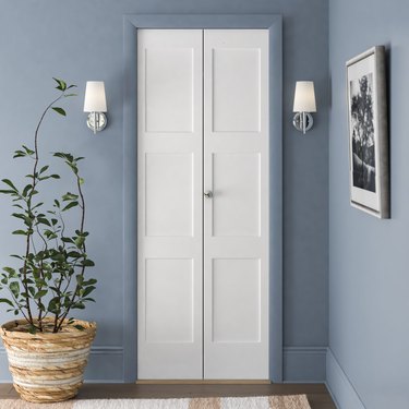 White bifold closet doors in a blue painted room