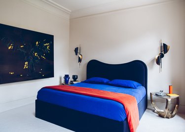 bedroom with navy blue, cobalt blue, and burnt orange palette