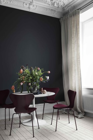 black dining room with burgundy dining chairs