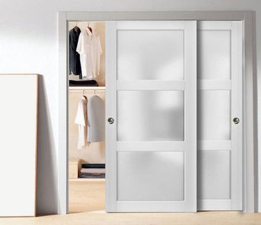 White sliding closet doors with frosted glass inserts