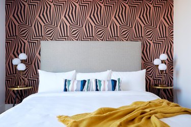 black and coral patterned wallpaper feature wall in modern bedroom