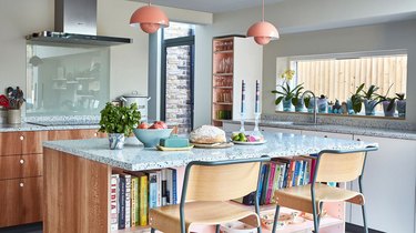 eclectic kitchen with gray walls and coral light fixtures and shelving