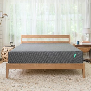 Wooden bed frame with gray mattress