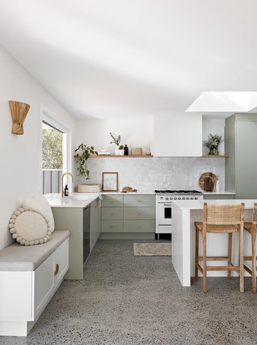 Sage green lower cabinets and gray backsplash tile