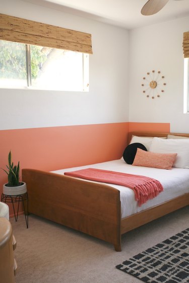 half painted coral wall in white and coral bedroom
