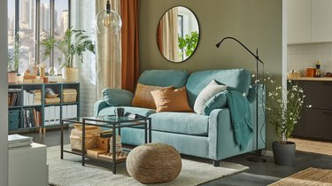 room with turquoise sofa and gold accents