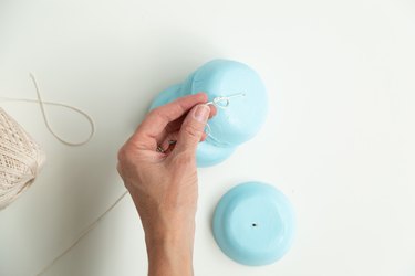 Threading together air-dry clay wind chimes