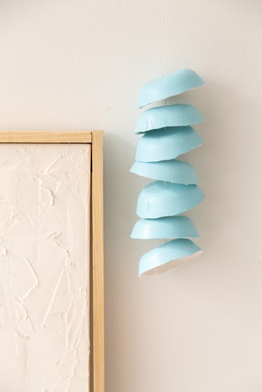 Hanging blue wind chimes on wall