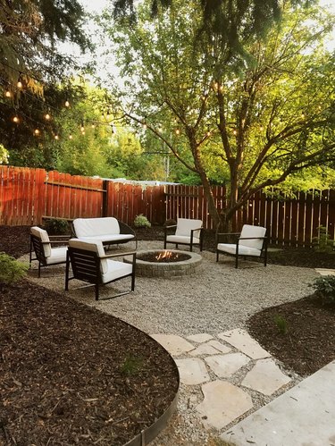 rounded patio with fire pit and lounge chairs