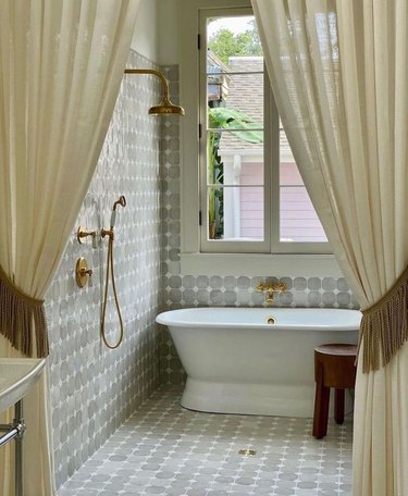 Wet room with circle tiles and a curtain divider