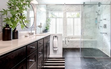 Wet room with white marble walls and black marble