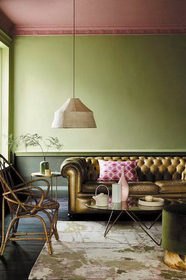 Bronze couch with olive green painted walls