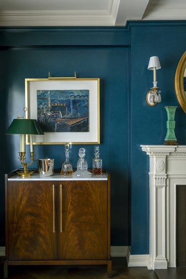 Living room painted teal with gold accents