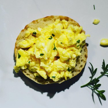 Microwaved scrambled eggs on an English muffin