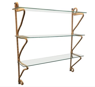 3-tired shelving unit with glass shelves and gold hardware