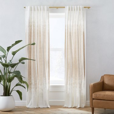 White curtains with gold geometric detailing