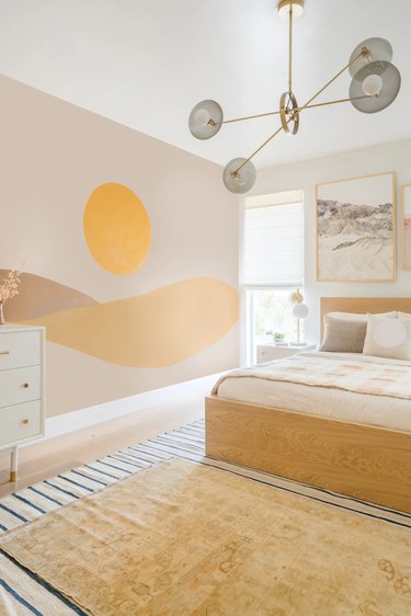 cream bedroom with yellow mural