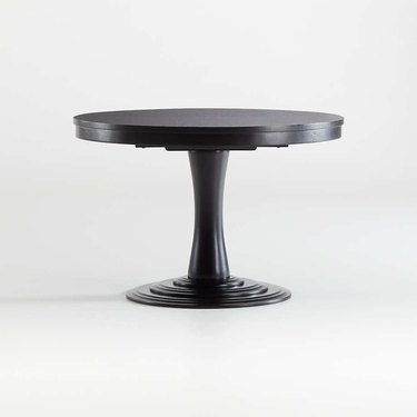Black pedestal round, extendable dining table from Crate & Barrel