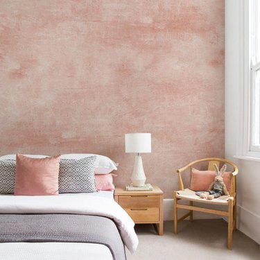 Bedroom with pink textured accent wall