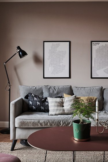 Living room with gray couch and pale plum wall