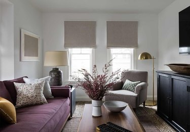 living room with burgundy sofa and greige accents