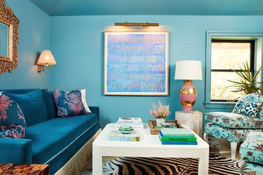 Turquoise living room with pink and gold accents