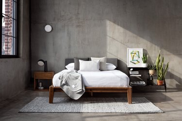 room with gray walls and bed on bed frame