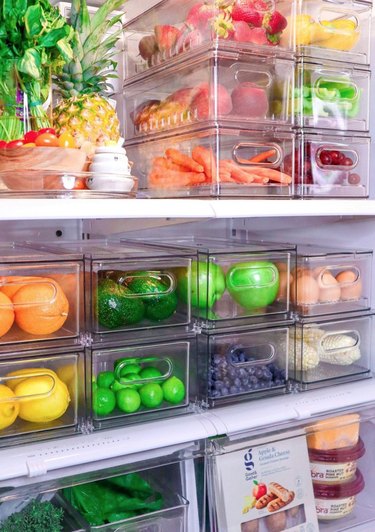 Refrigerator organized with clear plastic containers.