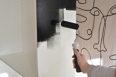 Painting bookcase black with a roller